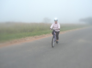 woman riding bicycle in fog